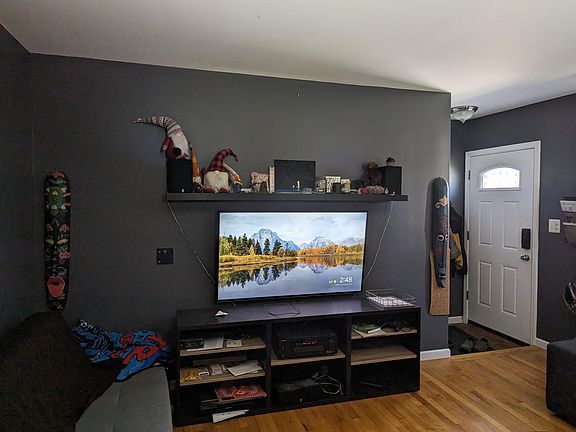 Living room while furnished. TV, couch, & gnomes not included in rental.