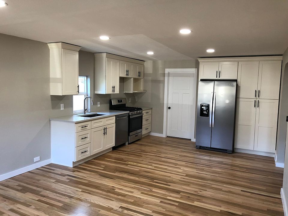 Updated kitchen with gas range, dishwasher, side-by-side refrigerator with ice-maker/water dispenser, and plenty of pantry storage.