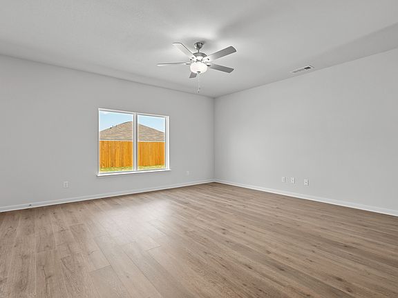 The living room is spacious and has plenty of space for family and friends.