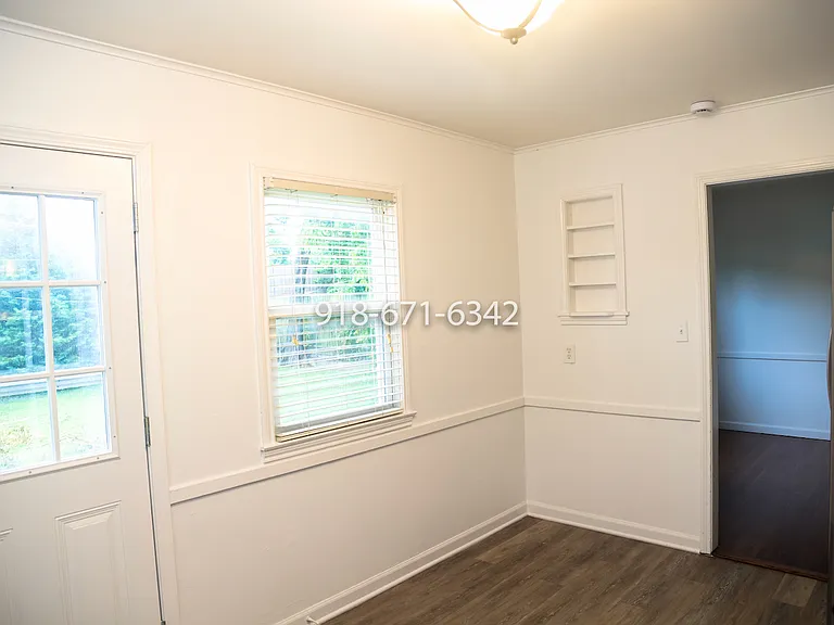 View from kitchen, showing back door and dining room.