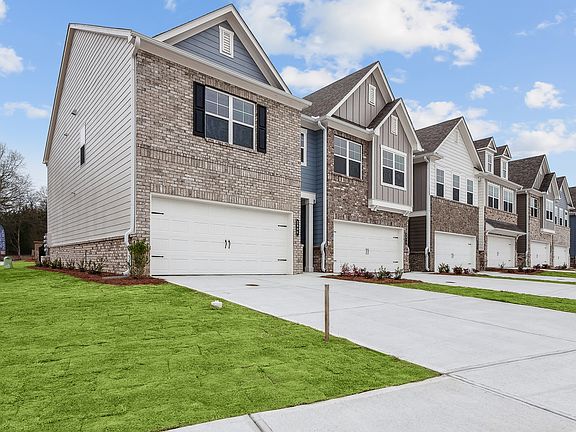Side view of Carlton Crossing with a private driveway and attached garage.