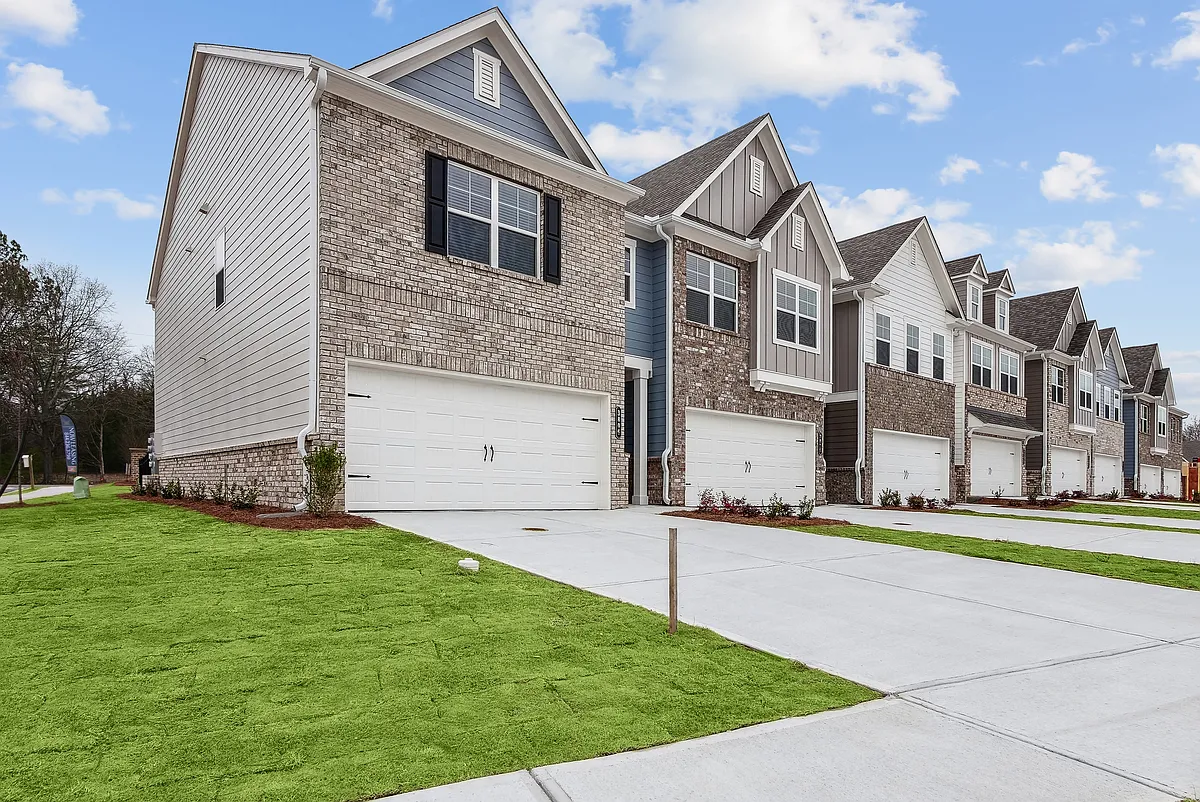 Side view of Carlton Crossing with a private driveway and attached garage. - Poplar Row
