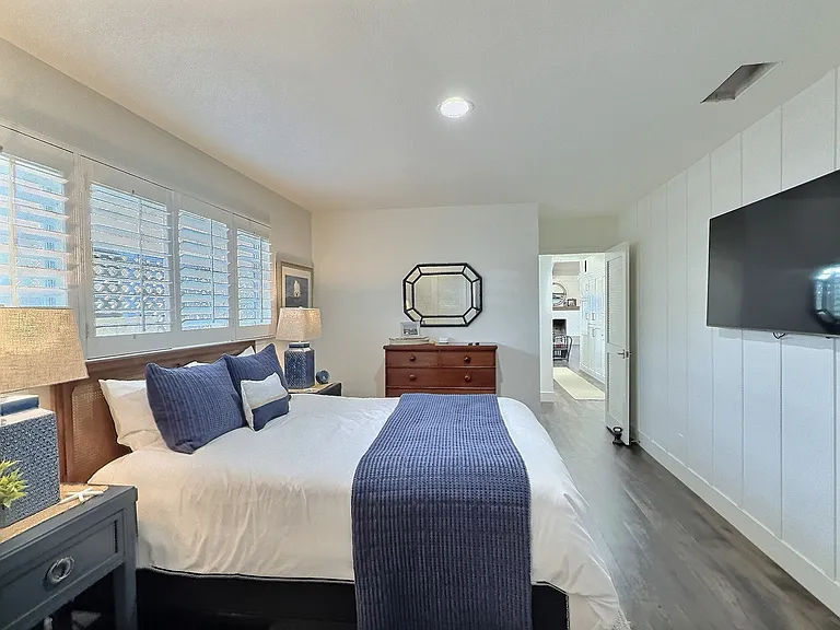 The third bedroom has a queen bed. The soft, airy palette and relaxed textures create a serene, breezy vibe that captures the essence of laid-back beachside living.