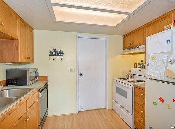 Kitchen with door leading to extra long garage and laundry a
