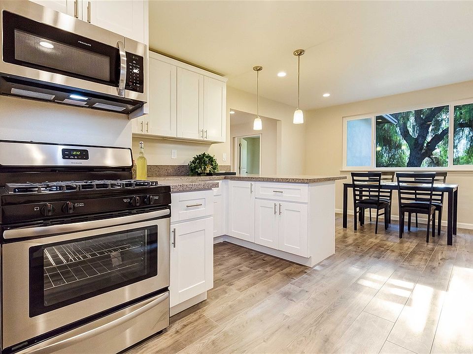 New custom kitchen with beautiful quartz counter tops, stainless steel appliances, & new floors.