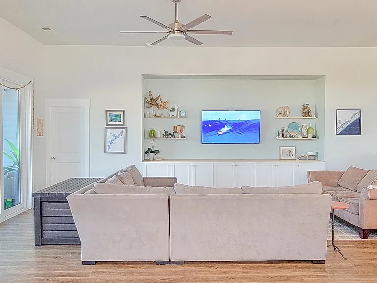 Large open living room opens to screened in porch