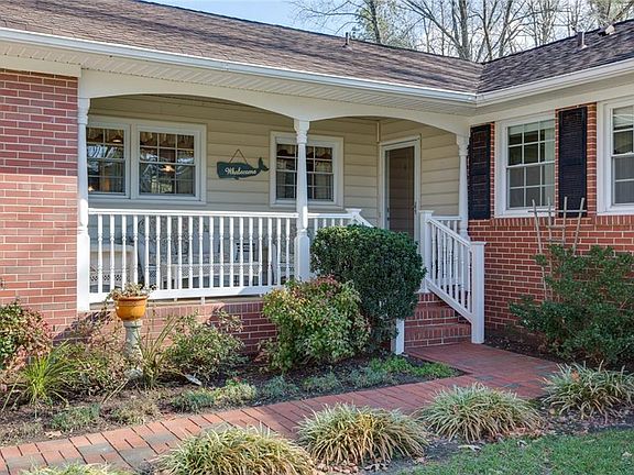 LARGE FRONT PORCH WITH ROOM FOR CHAIRS AND TABLE. 