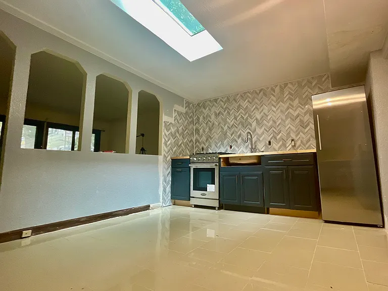 FULLY-remodeled, eat-in kitchen with gleaming natural light from the skylight