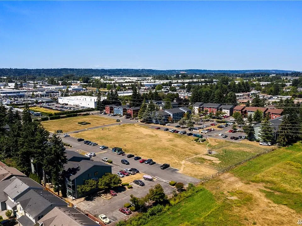 Aerial photo of entire complex complete with large open space including fenced dog area.