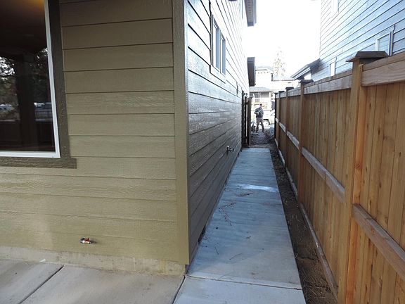 Sidewalk to backyard. Natural Gas BBQ connection on back porch.