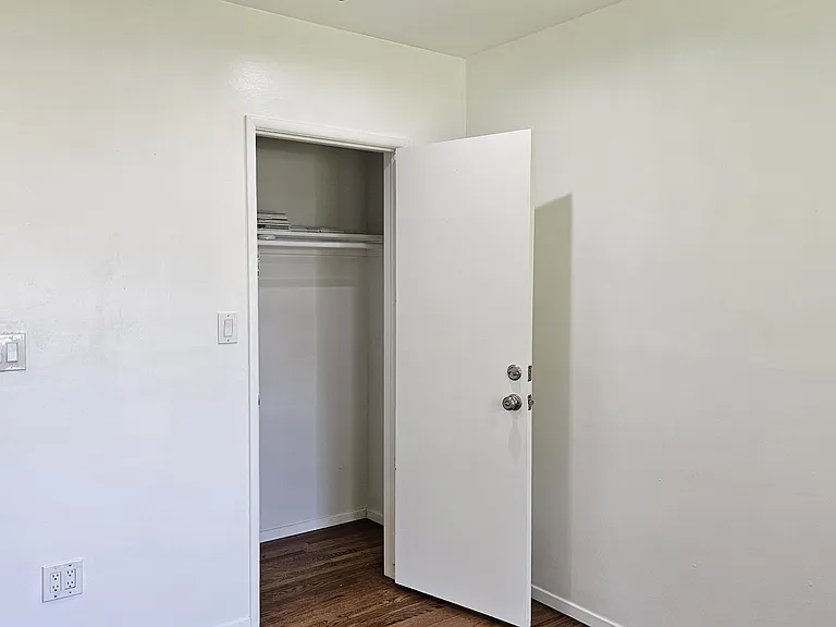 Bedroom, with closet door open.