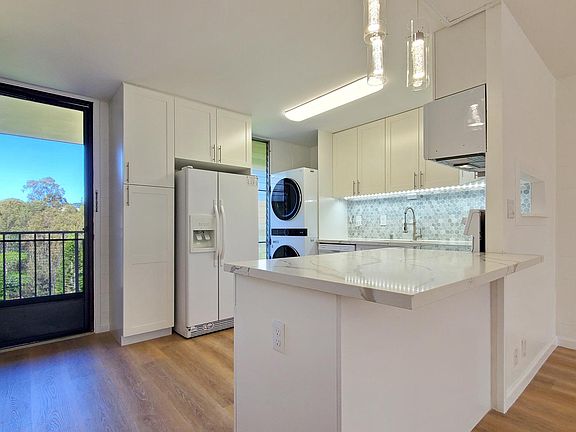Newly remodeled open kitchen with quartz countertops, soft close cabinets, and luxury vinyl flooring