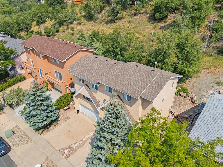Aerial view of house nestled amongst trees in vibrant Old Colorado City neighborhood