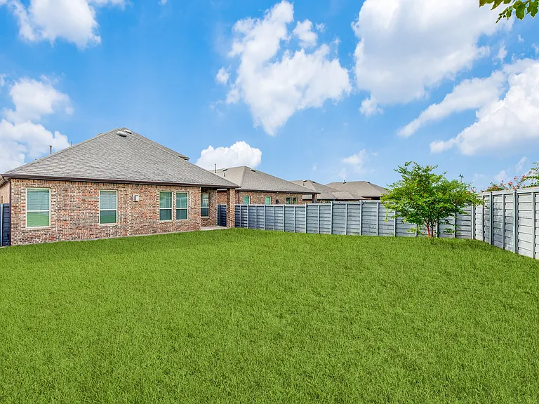 Huge backyard with large grass area.