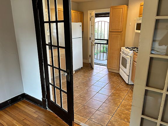 This view is through the living room French doors into the kitchen, showing the back door onto the deck.
