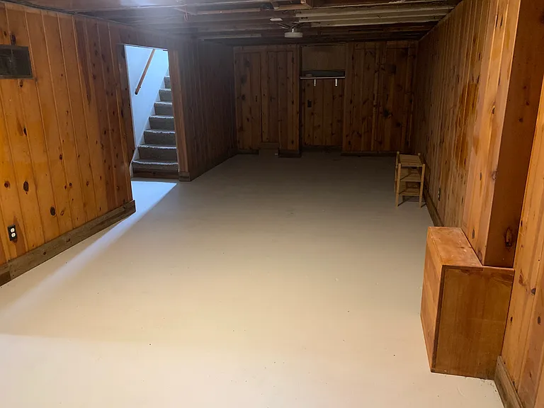 Clean, newly renovated basement with fresh concrete flooring. Could be used as a den, office, or playroom. heating vent can port heat to the basement if desired.