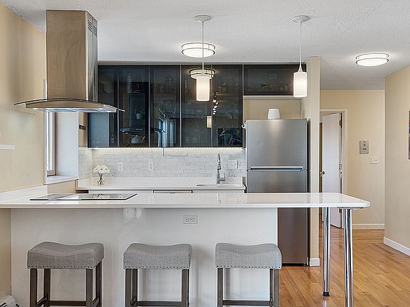Open Floor Plan. High End Kitchen with Directly Vented Hood; Quartz Countertop, Marble Backsplash, Bosh Oven and Induction Cook Top