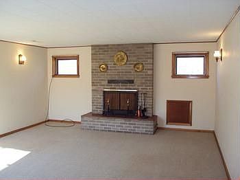 Large living room with a brick fireplace.