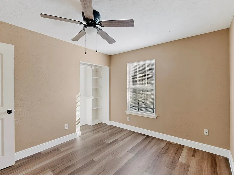 Unfurnished bedroom featuring light wood-style floors, a ceiling fan, and a closet