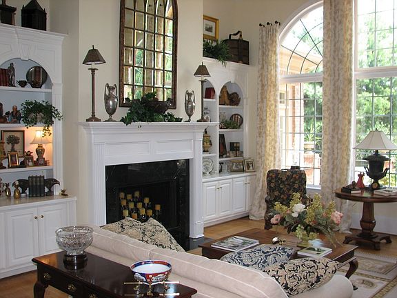 Black marble fireplace surrounded by custom built-ins. 