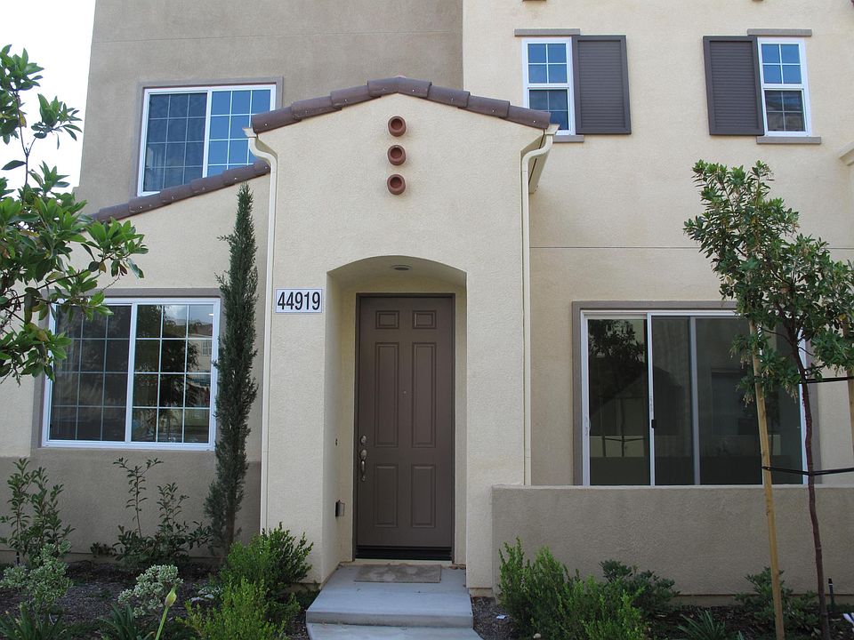 Condo front door and entry. Sliding doors give access to small patio area.