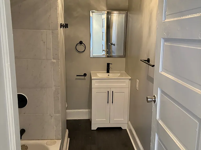 Completely Renovated Full Bath! New Sherwin Williams Designer Paint, New Luxury Vinyl Tile, Vanity, Lighting, Hardware and Shower Head.