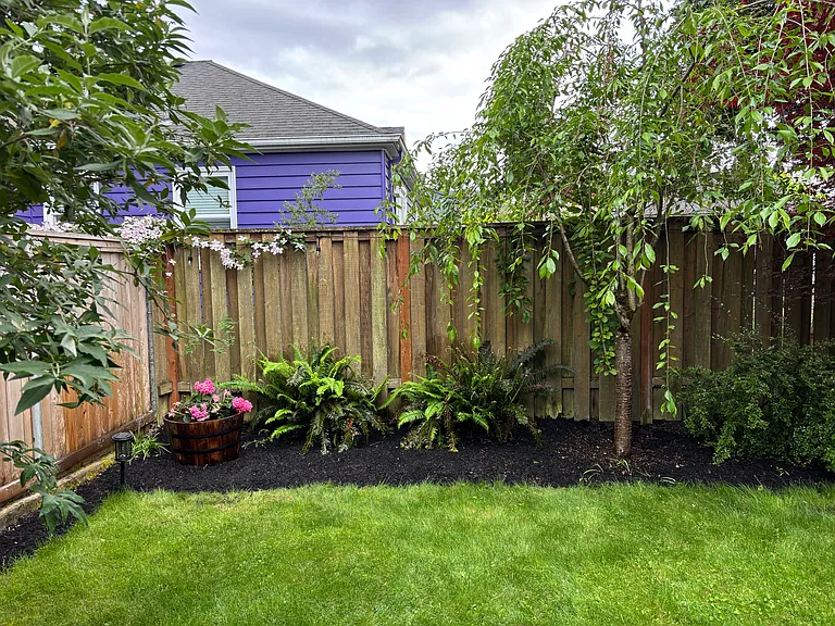 Yard has a small garden box + backyard patio.