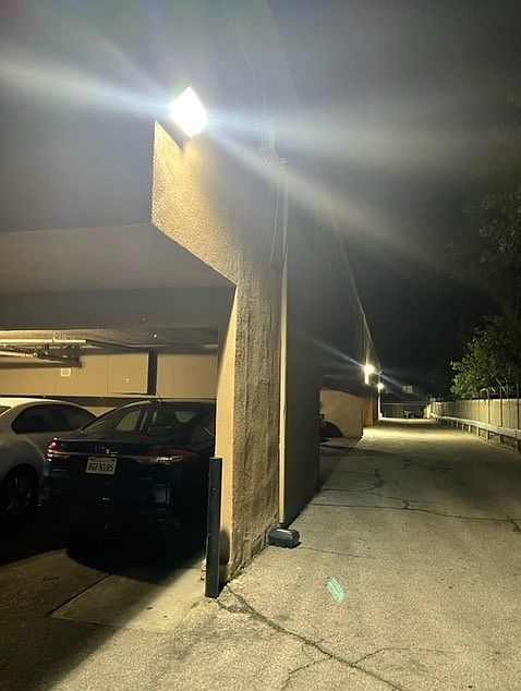 Carport parking area shown well lit at night