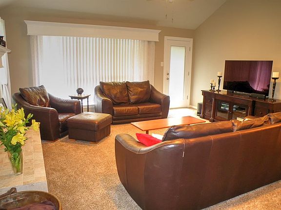 Living area with lots of room, high ceilings and a fireplace