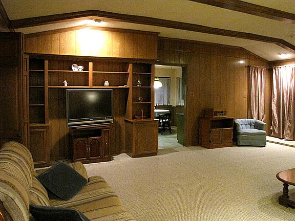 Family room with solid wood built-ins and carpet installed Oct and never lived on