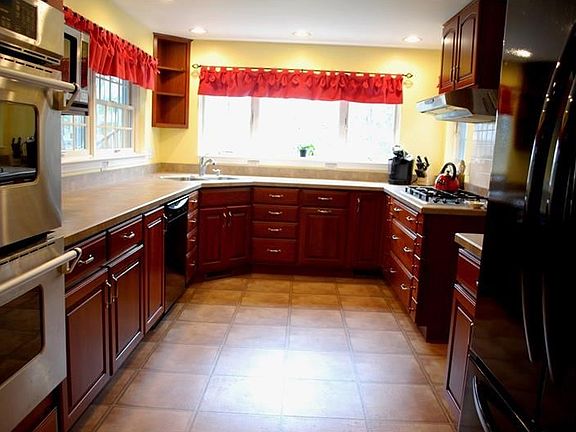 Sunny kitchen overlooking expansive back yard. Gas cooktop, double stainless sink, and double oven.
