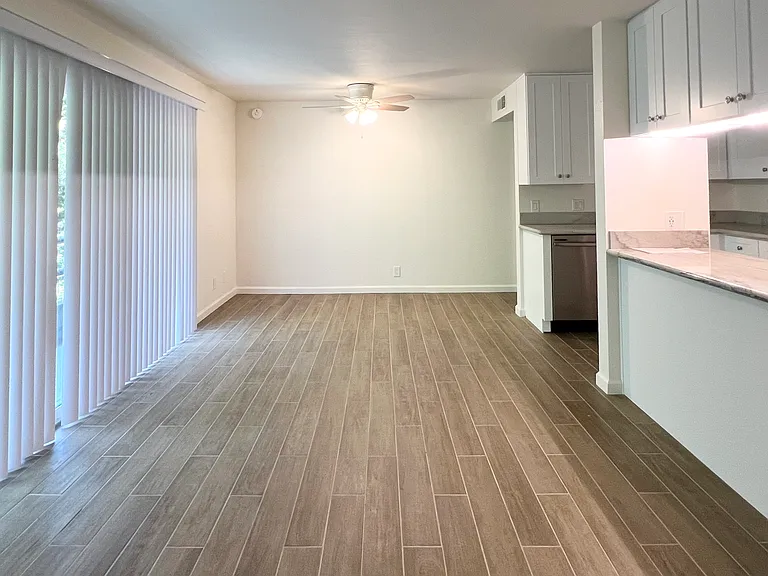 Living and Dining Room w/ tile flooring and access to the balcony