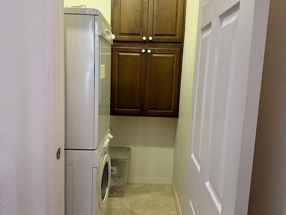 Laundry room - stackable washer and dryer.