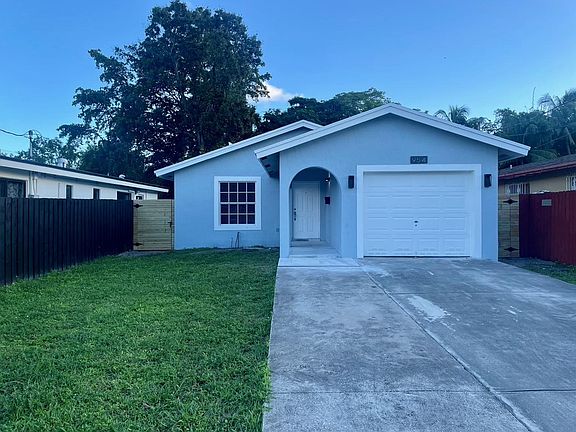 Wide driveway and covered walkway to the front door.