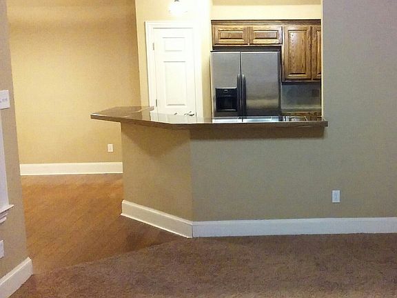 Kitchen overlooks living room.