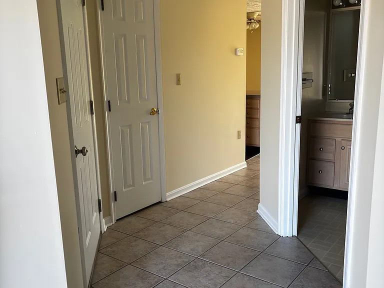 Entry/Foyer showing entrance to half bath/laundry room.
