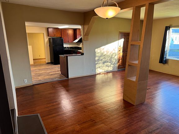 Very spacious living room looking into kitchen.