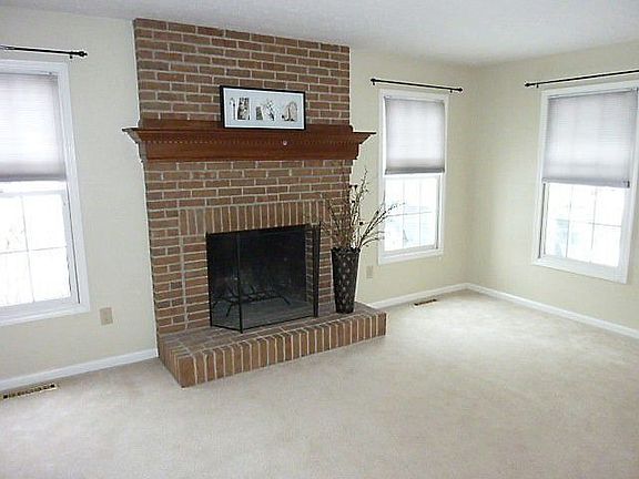 Spacious family room (approx. 17'3" x 12'11") with brick fireplace.