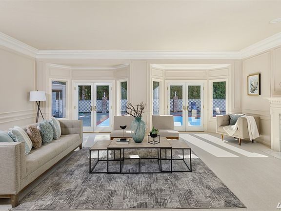 Formal sunken living room with fireplace and doors to outside pool.