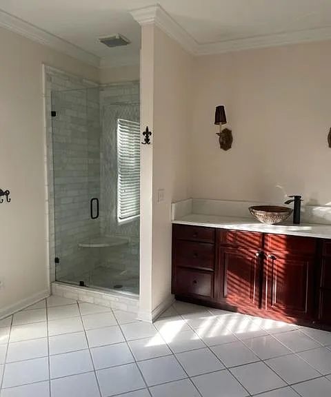 Ample master bathroom with sink, shower and toilet in an adjacent room.