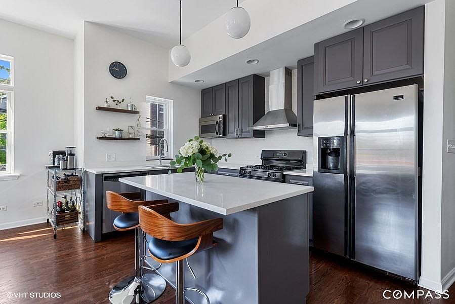 Georgous kitchen with stainless steel appliances, quartz countertops, and modern finishes.