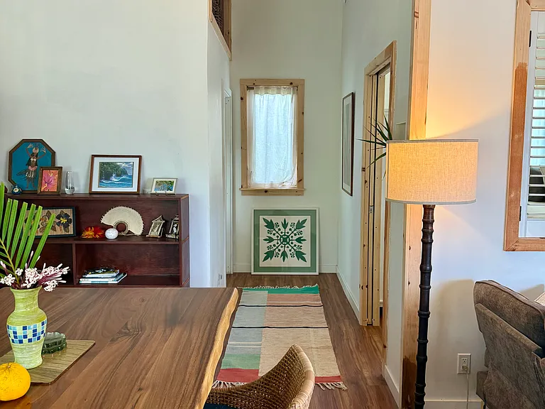 Hallway leading to bedroom and bathroom. Artistic feel throughout the home