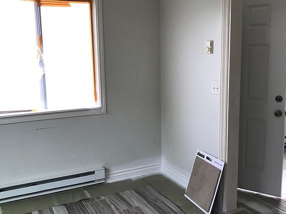 View of dining room off of kitchen & living room. In the process of painting.