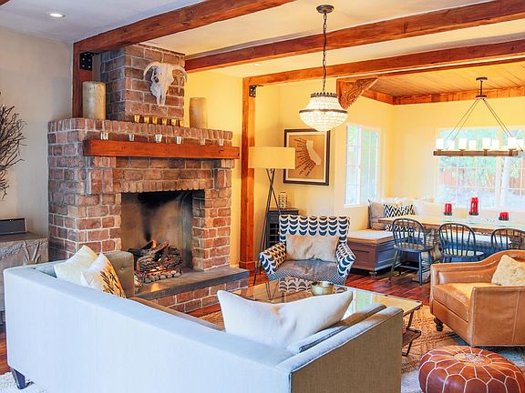 Warm and cozy living area anchored by huge brick fireplace (gas). This room opens up to the front patio for wonderful indoor/outdoor living.