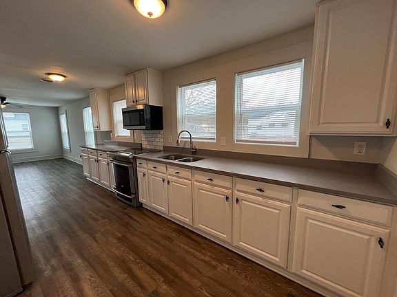 Large open kitchen with quartz countertops connects to living room forming a very livable great room.