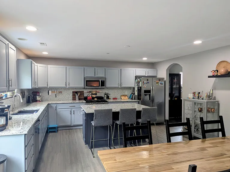 Large Kitchen includes gas oven, fridge, microwave, dishwasher, and disposal. Quartz countertops and island. 5' x 4.5' Island seats four.