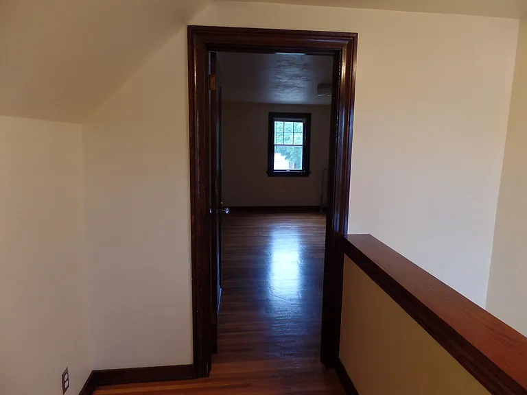 Landing at the top of the stairs. Upper Bedroom through door.
