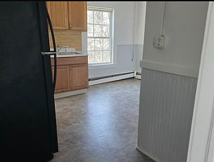 Picture from one of the front bedrooms looking into sunlit kitchen.