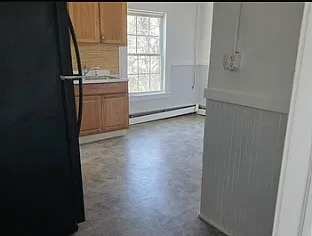 Picture from one of the front bedrooms looking into sunlit kitchen.