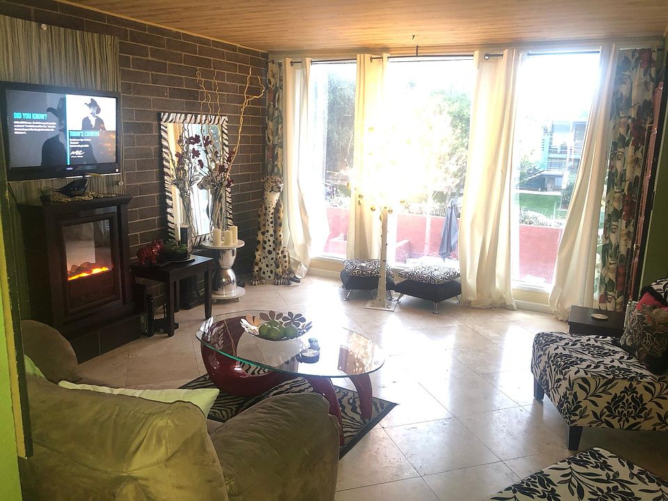 travertine floors throughout this amazing space. Huge windows overlooking the pool.